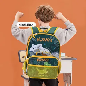 Kids dinosaur themed school backpack for grades 1-3 shown on model in classroom
