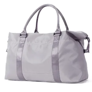 Detailed side view of a gray water-resistant travel duffel bag with sturdy handles.
