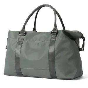 Side view detail of a durable grey travel duffle bag with reinforced straps