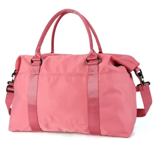 Side view of a durable pink travel duffel bag with reinforced handles and strap.
