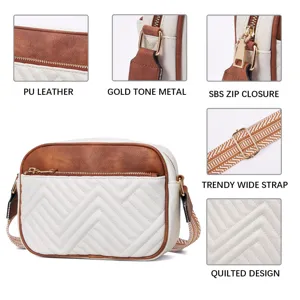Detailed view of quilted faux leather crossbody bag with golden hardware and wide strap