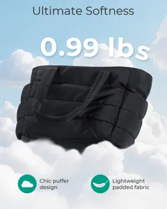 Detailed view of lightweight black quilted puffer tote bag on clouds, weighing 0.99 lbs