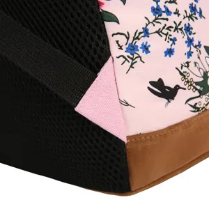 Détail de sac à dos décontracté avec motif floral rose, poche en maille noire et base marron.