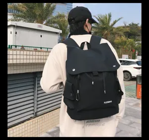 Detailed back view of a black water-resistant large-capacity backpack worn by a model.