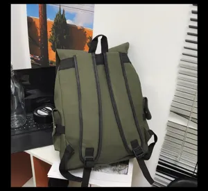 Back view of a waterproof olive green large capacity backpack on a modern office desk