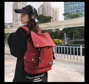 Asian model wearing a stylish large red waterproof backpack in urban street setting