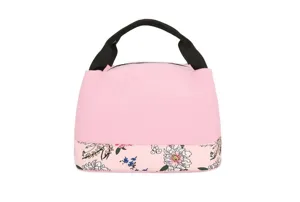 Sac à déjeuner rose avec anses noires et motif floral en bas, vue détaillée du fourre-tout.