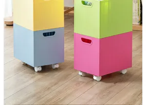 Close-up of colorful stackable plastic storage bins with rolling wheels on wooden floor