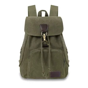 Detail of a vintage green canvas backpack with brown leather accents and metal clasp.