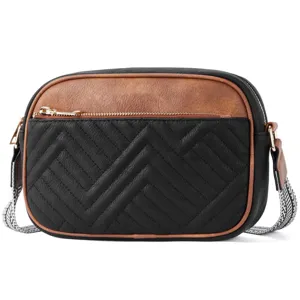Close-up of a vintage quilted color-block crossbody bag with wide patterned strap.