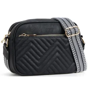 Elegant black faux leather crossbody bag featuring chevron quilting and a wide guitar strap