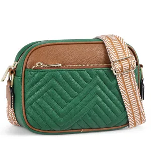 Detailed macro view of green and brown quilted crossbody bag with chic patterned strap
