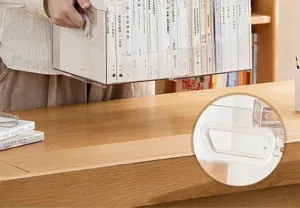 Close-up detail of transparent desktop book storage box with white EVA cushioned handles.