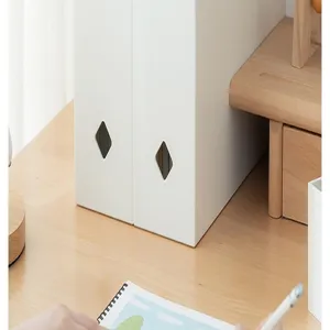 Close-up of minimalist white plastic file storage boxes with diamond cutouts on desk