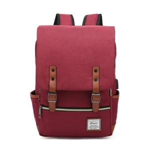 Front view of a stylish burgundy retro canvas laptop backpack featuring USB charging port