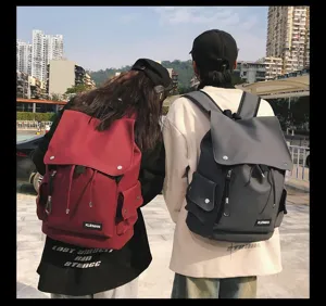 Rear view of waterproof couple backpacks in burgundy and grey for school and travel