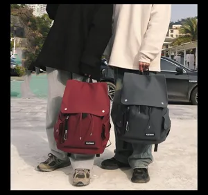 Detail view of stylish waterproof large capacity backpacks in red and grey outdoor scene