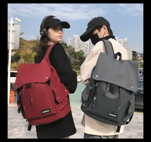 Urban lifestyle view of large capacity waterproof student backpacks in red and grey