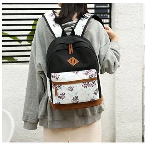 Sac à dos en toile à fleurs décontracté avec détails en cuir marron pour étudiants.