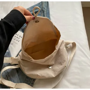 Detail view showing the spacious interior and magnetic snap of the beige nylon bag