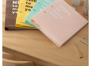 Detailed view of colorful A4 ring binders with motivational text on a wooden desk