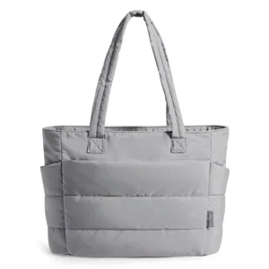 Detailed view of large capacity grey puffer tote bag with quilted texture and side pockets