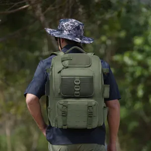 Back view of a person wearing a green tactical fishing backpack in a lush forest