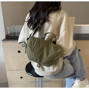 Army green nylon dumpling crossbody bag for sports and fitness shown on a model