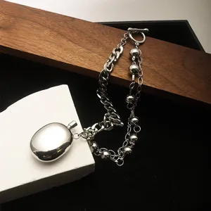 High-quality close-up of a silver Y2K style necklace with a polished oval pendant