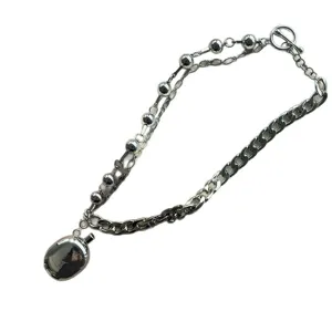 Stylish silver-toned Y2K double-layer necklace featuring a large oval pendant and Cuban chain