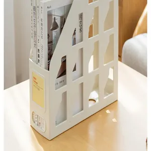 White plastic multi-compartment file rack organizer on a wooden table with books inside