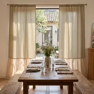 Tende oscuranti a quadretti in stile rustico in una calda sala da pranzo accogliente