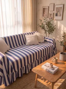 Detailed shot of blue and white striped sofa cover with elegant ruffle edge in sunlight