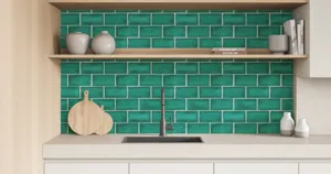 Kitchen detail view showcasing green 3D brick wall stickers in a stylish modern interior.