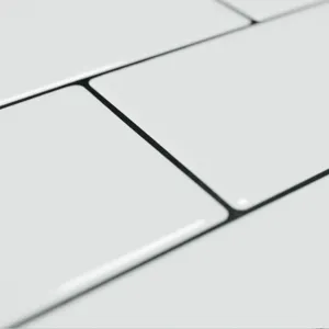 Detailed macro view of 2.2mm thick white 3D self-adhesive subway tiles with grout