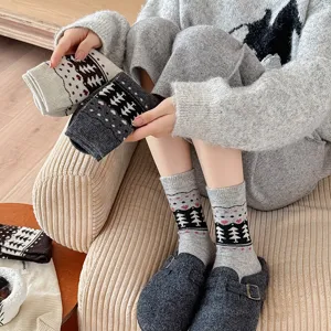 Detail view of retro Fair Isle pine tree wool socks styled with grey buckle clogs