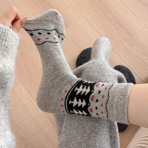 Detailed view of gray wool socks with vintage Fair Isle tree pattern and soft knitted texture