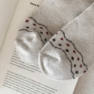 Close-up detail of vintage Fair Isle wool socks featuring red and black wave patterns