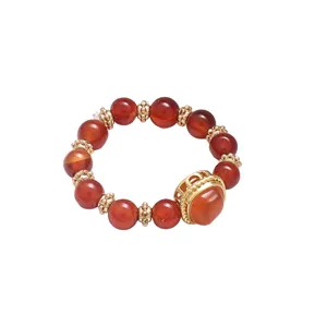 Close-up of a luxury red carnelian beaded ring with gold-tone accents for women.