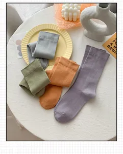 Detailed view of women's mid-calf cotton socks in various trendy colors on table