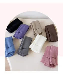 Close-up details of assorted colorful knitted leg warmers, showing rich textures and varied hues.