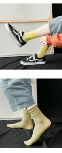 Detail view of thin candy-colored velvet crew socks for women in soft yellow and olive green