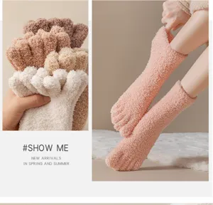 Detail showing the soft coral fleece texture of five-finger winter floor socks for women.