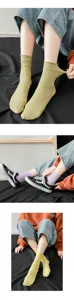 Detailed view of women pastel green and purple ribbed velvet mid-calf slouchy socks