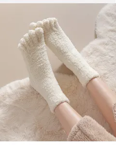Close-up of soft cream coral fleece five-toe thermal socks on fluffy rug