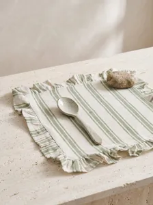 Detailed view of the green striped ruffled edge on the fabric placemat