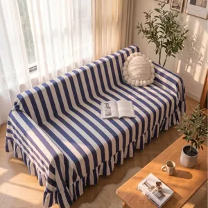 Premium blue and white striped velvet sofa cover with elegant ruffled edges for living room