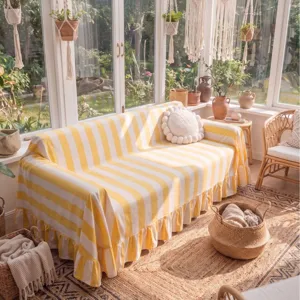 Cozy yellow and white striped velvet sofa cover with elegant ruffled edges for home
