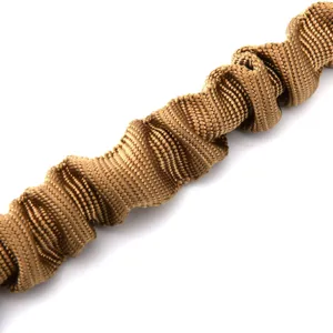 Tactical bungee safety rope detail, brown elastic braided retention cord surface texture.