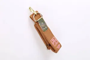 Detailed view of a brown tactical strap with a durable metal hook and D-ring attachment.